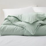Refresh your bedroom with the calming elegance of our Green Goose Feather & Down Comforter. The soft green hue adds a soothing, nature-inspired touch to any sleep space, while the breathable cotton shell and premium feather and down fill provide lightweight warmth and comfort. Perfect for creating a serene and stylish retreat with a pop of subtle color.