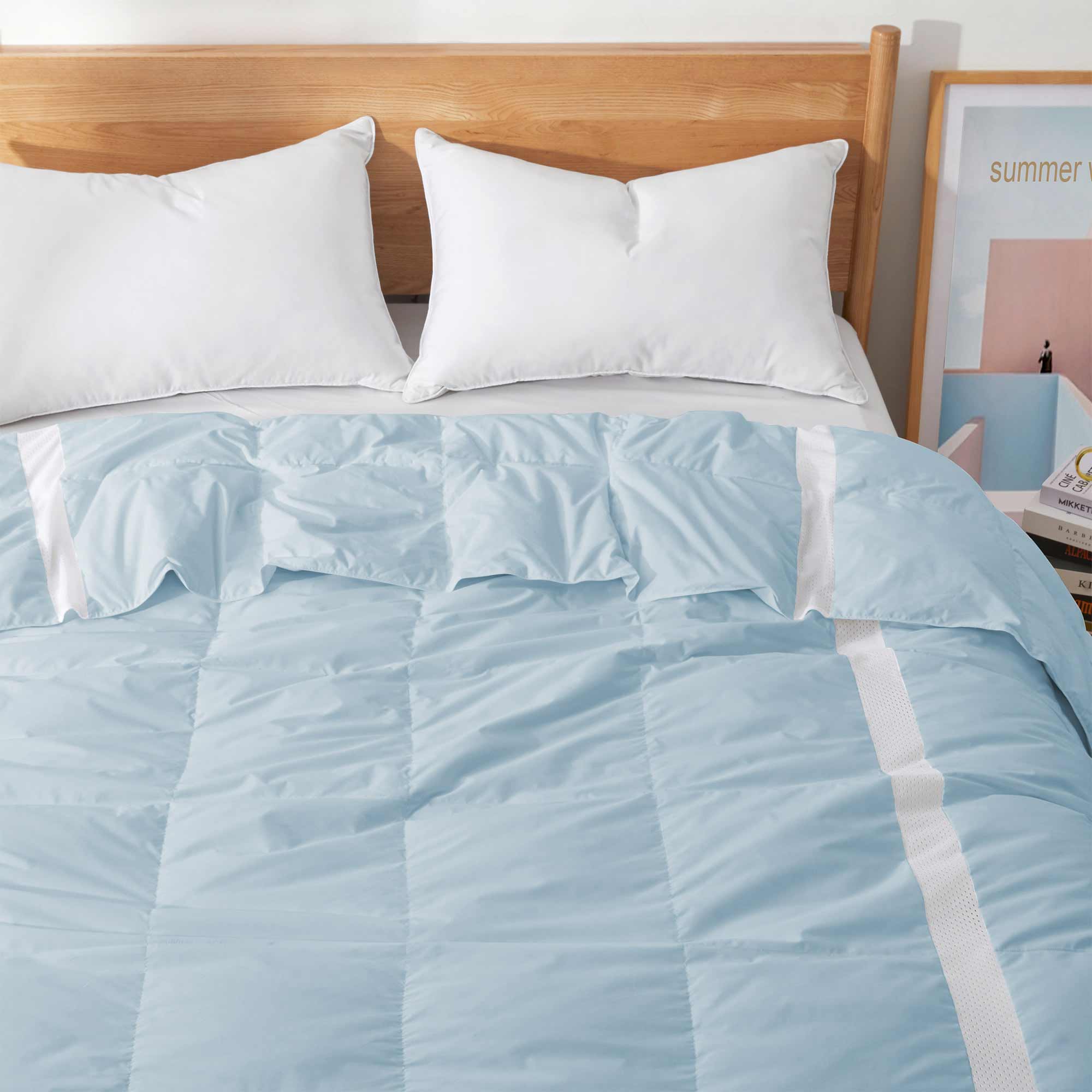 The luxurious comforter with corner tabs is enveloped in the cool tones of Sky Blue. Bring the icy cool freshness of the outdoors to your personal space with this feather down blanket.