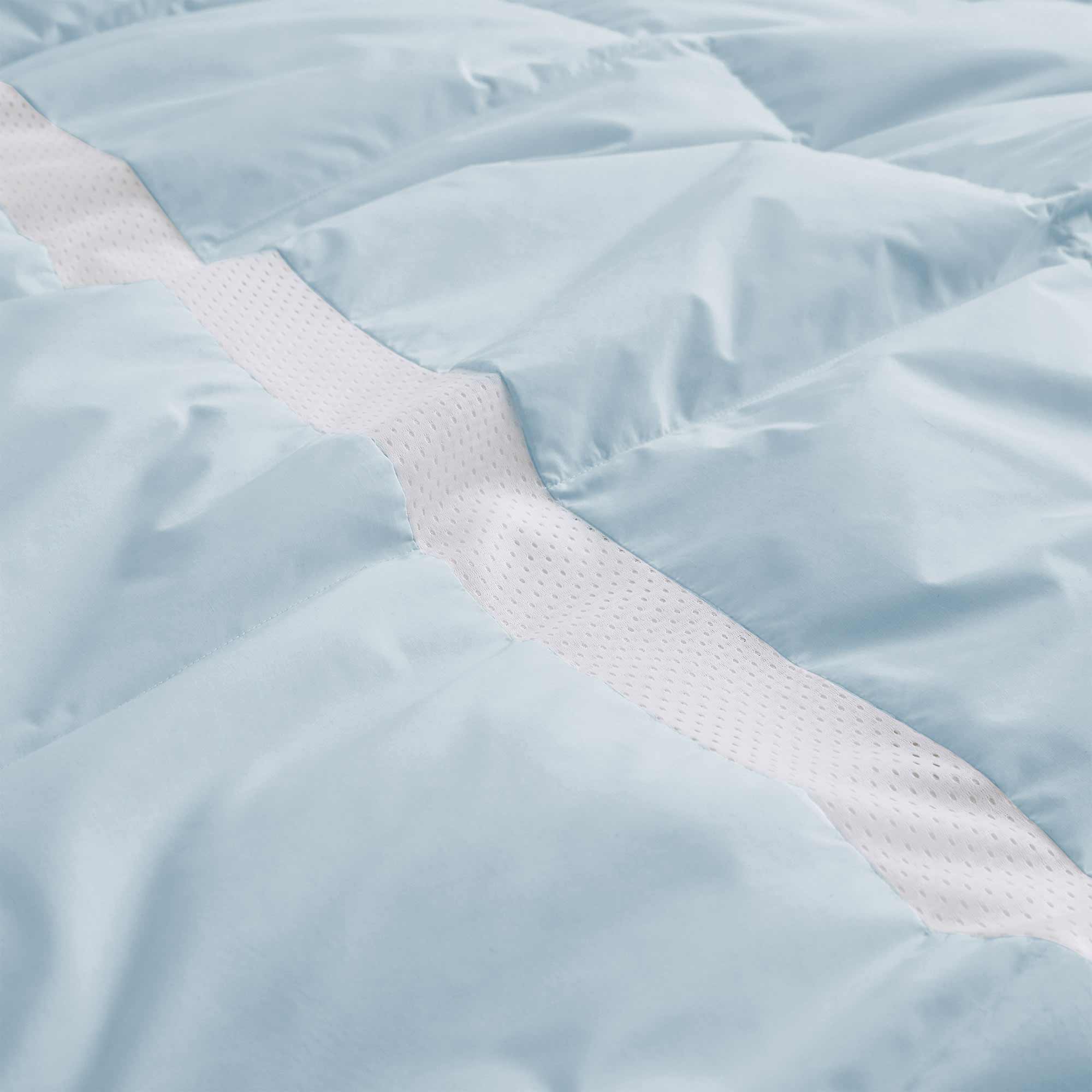 The luxurious comforter with corner tabs is enveloped in the cool tones of Sky Blue. Bring the icy cool freshness of the outdoors to your personal space with this feather down blanket.