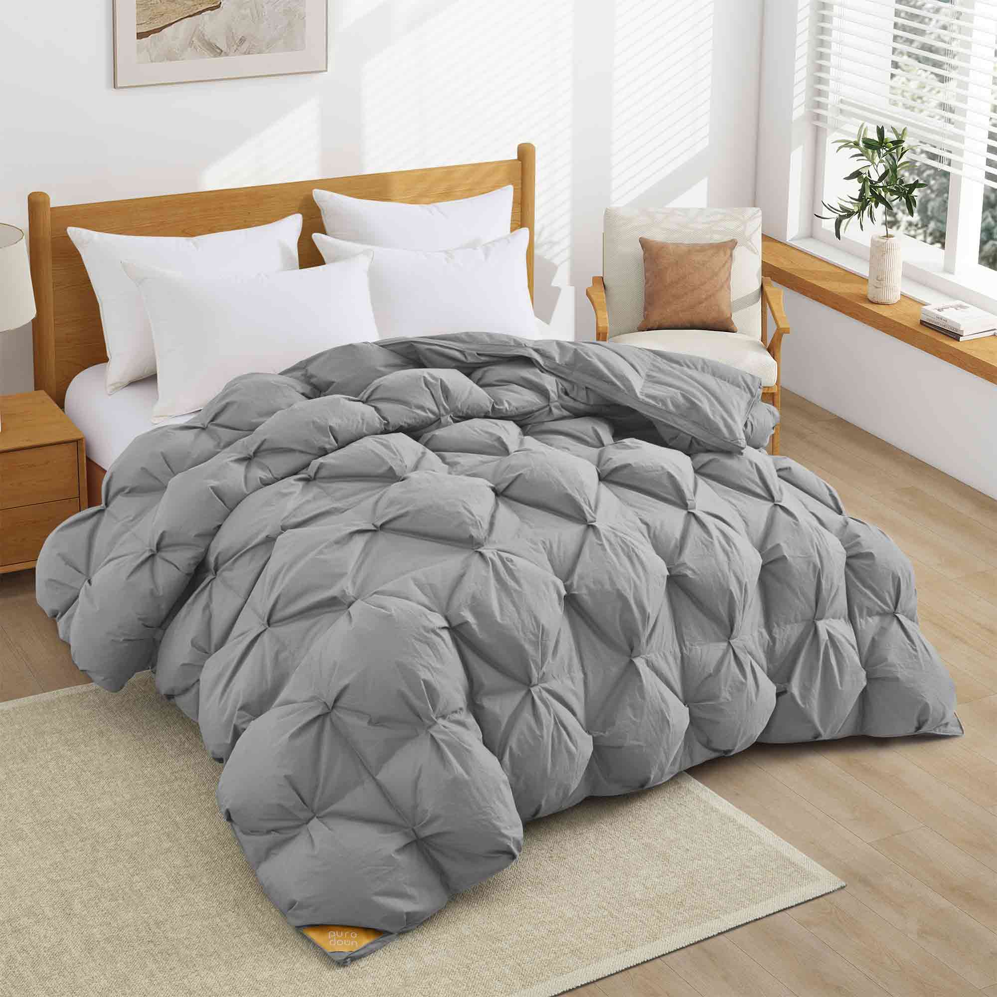 The medium warmth fluffy comforter is covered in the somber tones of gray. Add a touch of panache to your personal space with this high-quality all-season down comforter with corner taps for a snug sleep experience.