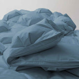 The organic cotton fabric cover comforter is brushed in the serene tones of Castle Blue. Bring an elevated level of warmth and fluffy comfort to your abode with this perfect weight comforter for a relaxing sleep experience.