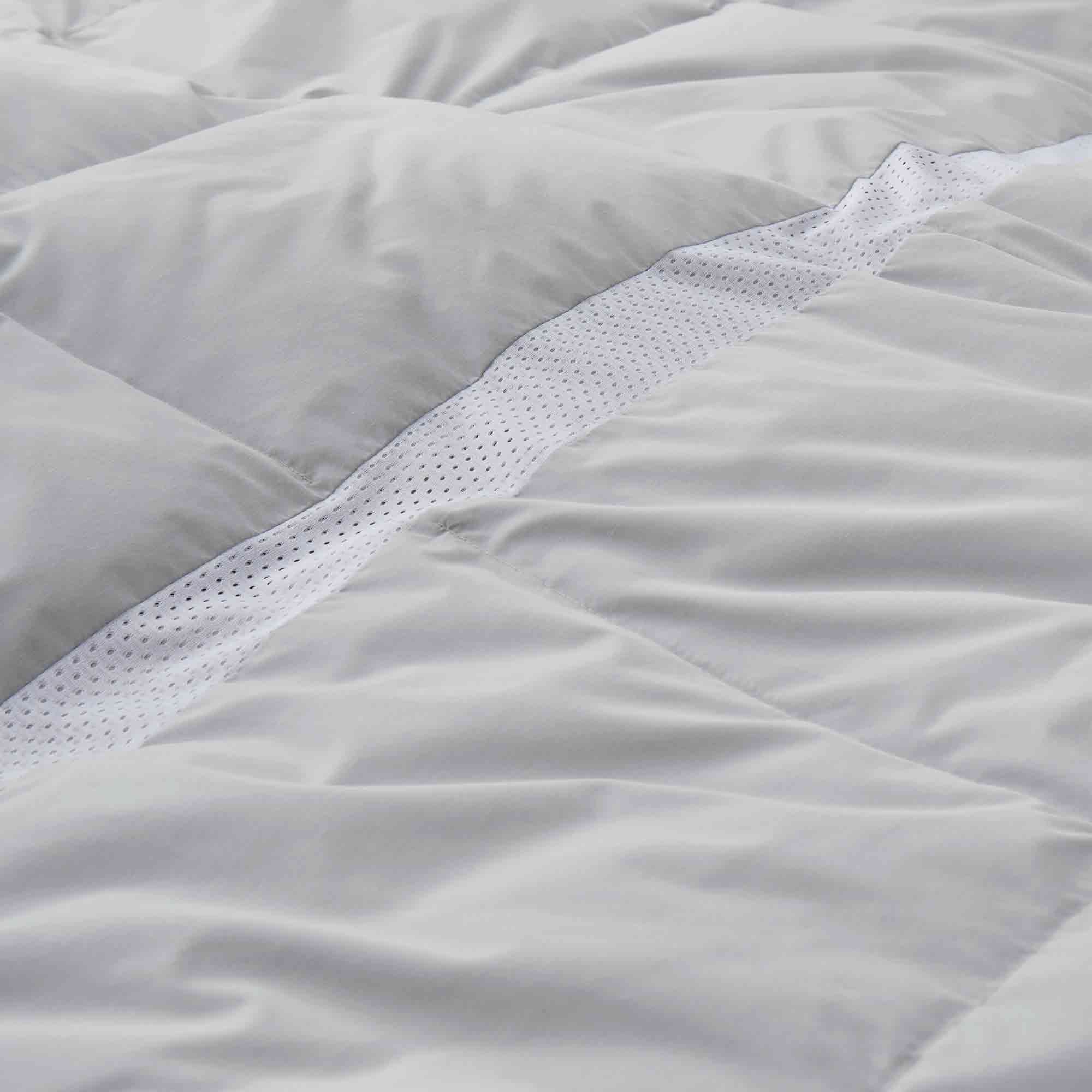 Elevate your sleep experience with the Ultra Lightweight Cooling Down Comforter in sleek gray—a perfect blend of style, breathability, and lightweight warmth. Tailored for hot sleepers and warm climates, this down comforter features cooling mesh fabric and a premium cover that promotes airflow and moisture-wicking to keep you comfortably dry all night