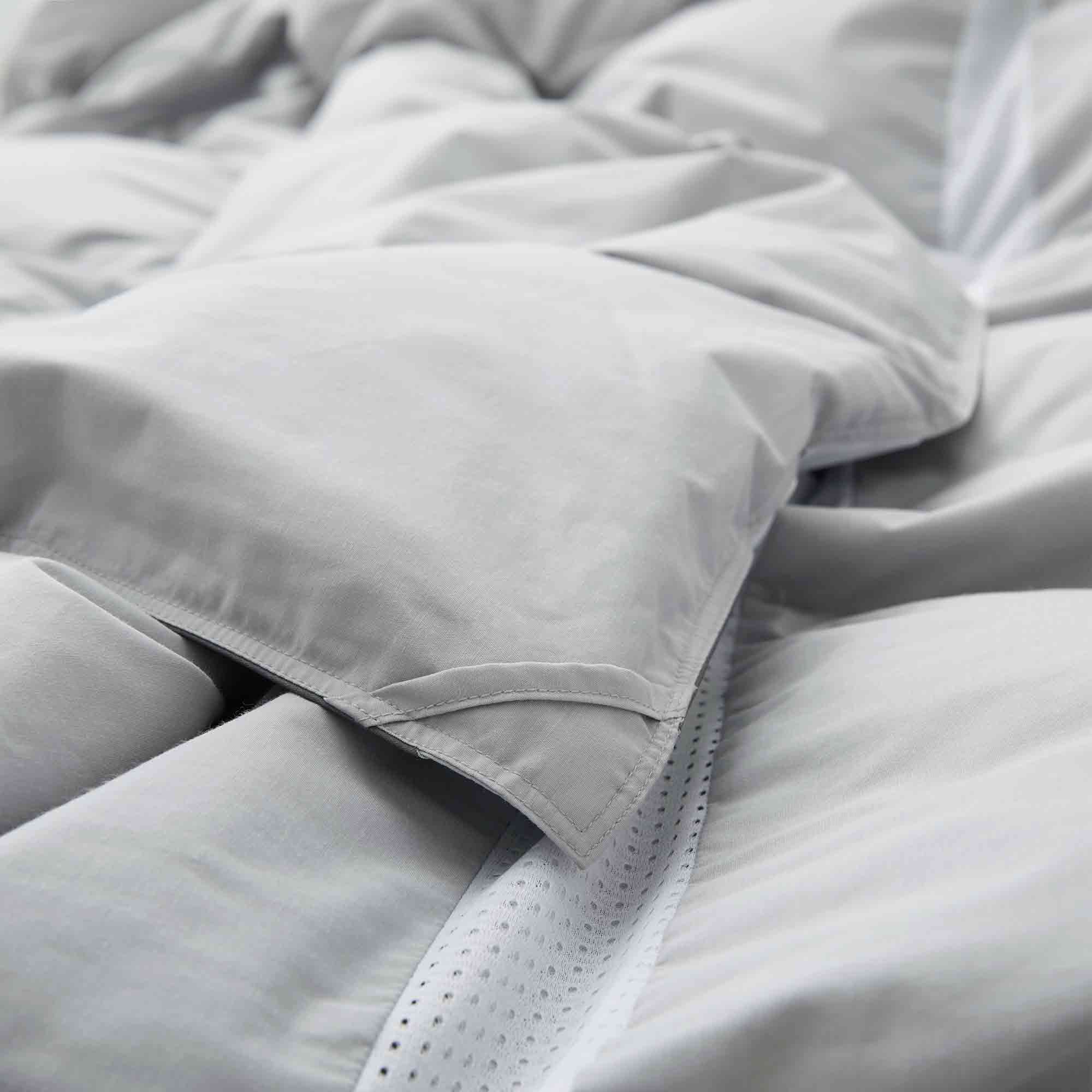 Elevate your sleep experience with the Ultra Lightweight Cooling Down Comforter in sleek gray—a perfect blend of style, breathability, and lightweight warmth. Tailored for hot sleepers and warm climates, this down comforter features cooling mesh fabric and a premium cover that promotes airflow and moisture-wicking to keep you comfortably dry all night