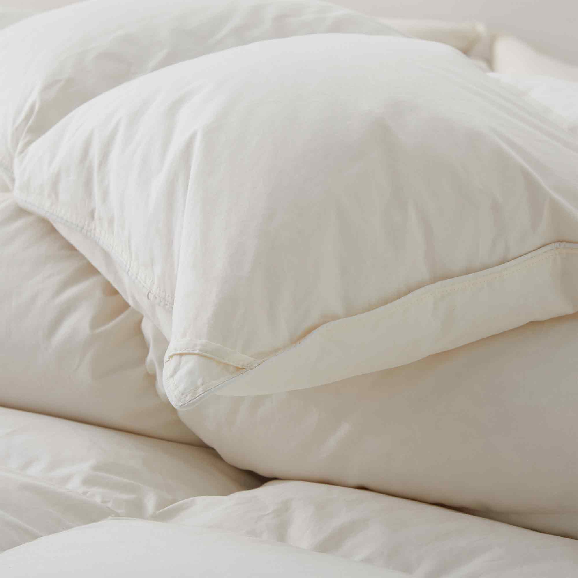 Crafted with a 100% organic cotton shell and filled with 90% natural white down, this comforter offers superior warmth and breathability. Its 800 fill power ensures a lightweight yet insulating sleep experience. Designed for year-round comfort, it features baffle box construction to maintain even fill distribution. Available in all-season and extra warm options, this comforter combines eco-friendly materials with luxurious softness for a restful night's sleep.