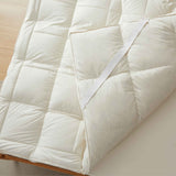 The plush surface of this feather blend mattress down topper is colored in pearly hues of off-white. Adding this feather mattress topper to your bedroom is an excellent choice for deep cushioning and additional comfort layer for a healthy sleep environment.