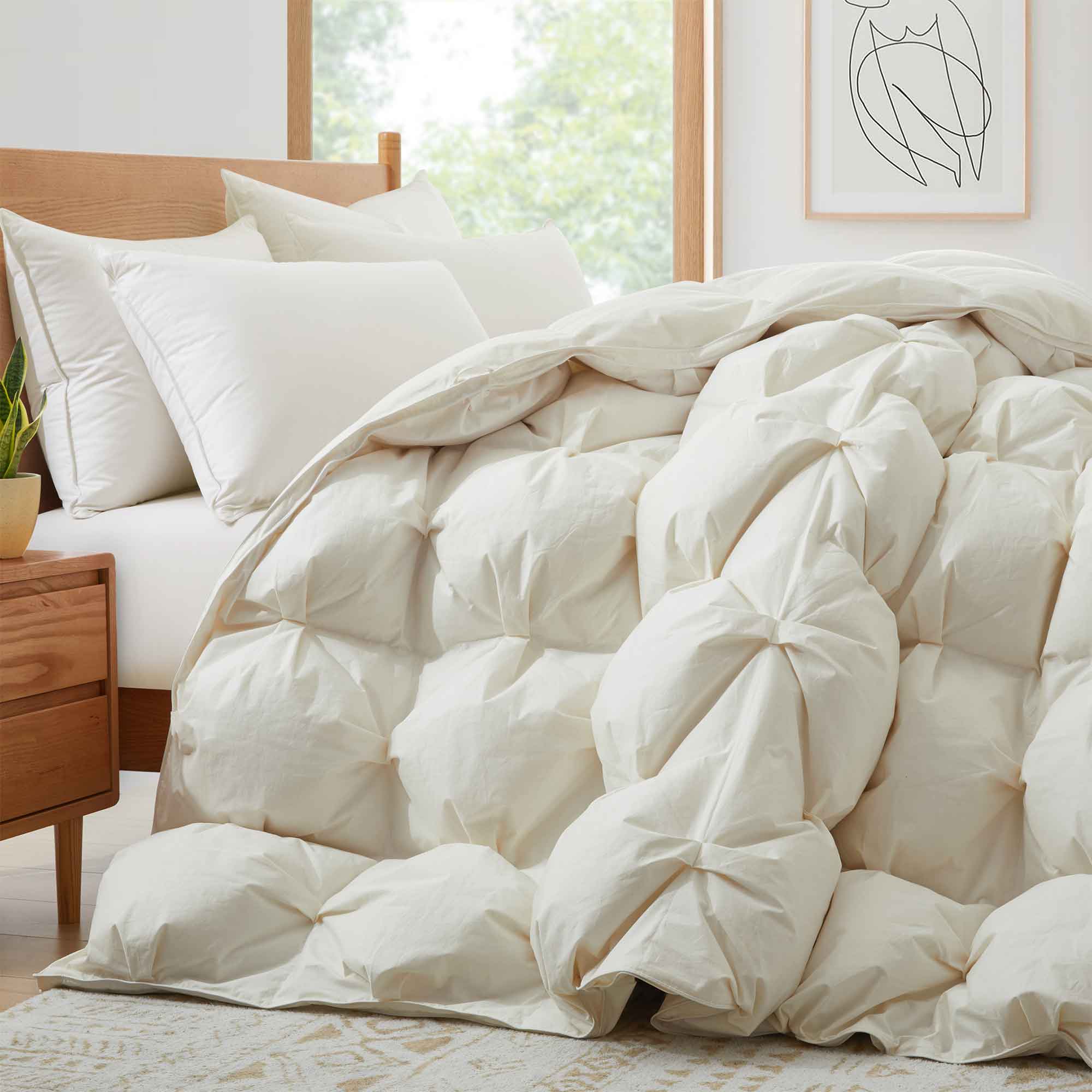 The down goose feather comforter is brushed in the pearly tones of off-white. Bring sophisticated elegance to your bedroom decor with this off-white bed comforter.