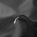 Deep charcoal gray duvet cover and pillowcases made from soft linen-cotton blend.