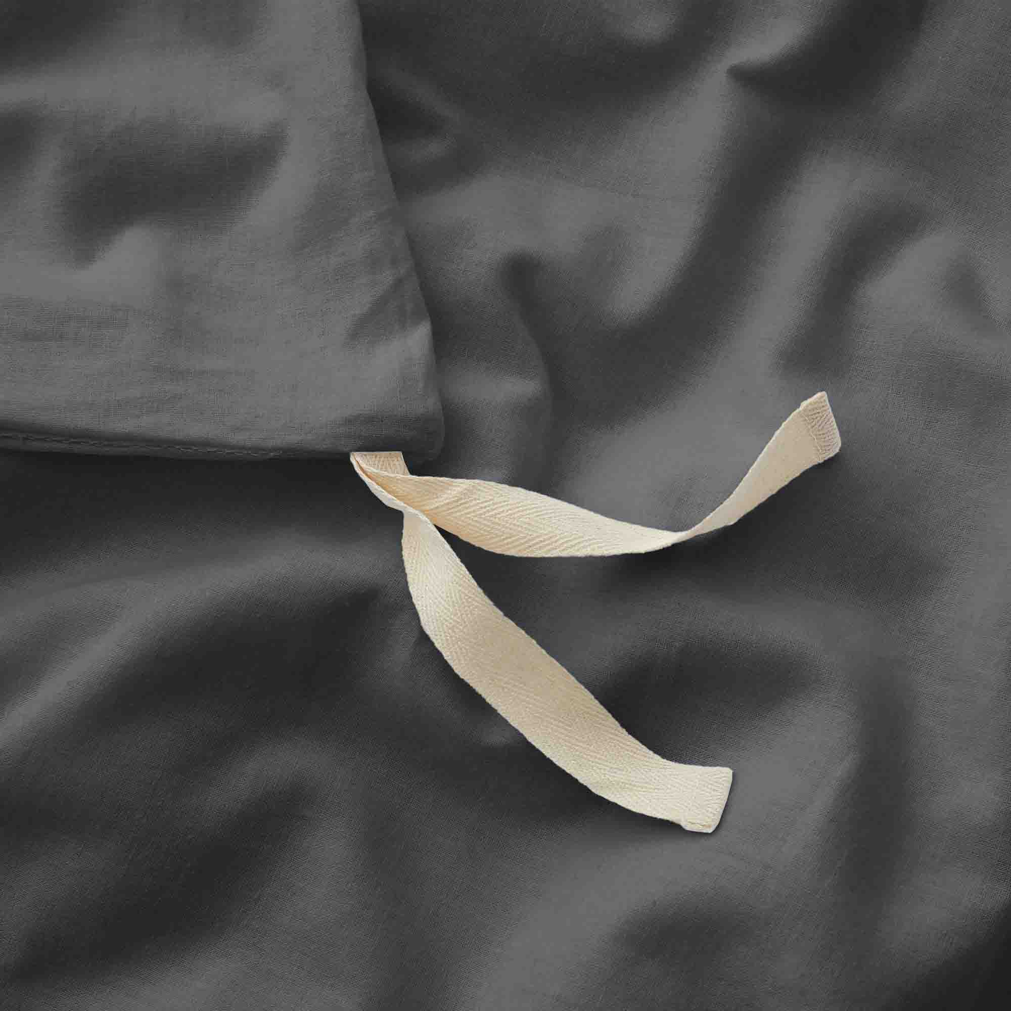 Deep charcoal gray duvet cover and pillowcases made from soft linen-cotton blend.