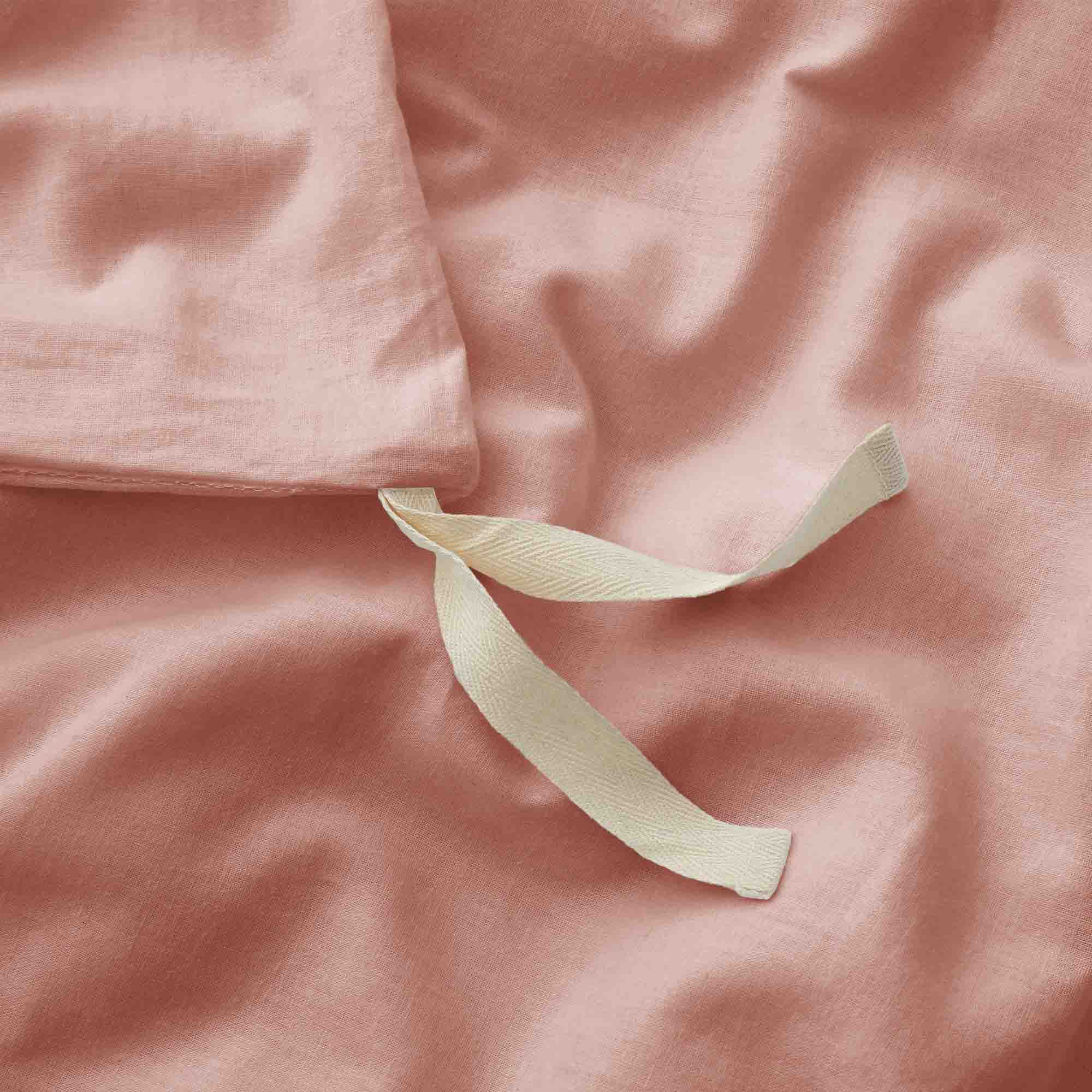 Soft rose taupe linen-cotton duvet cover and pillowcases in muted pink-beige.