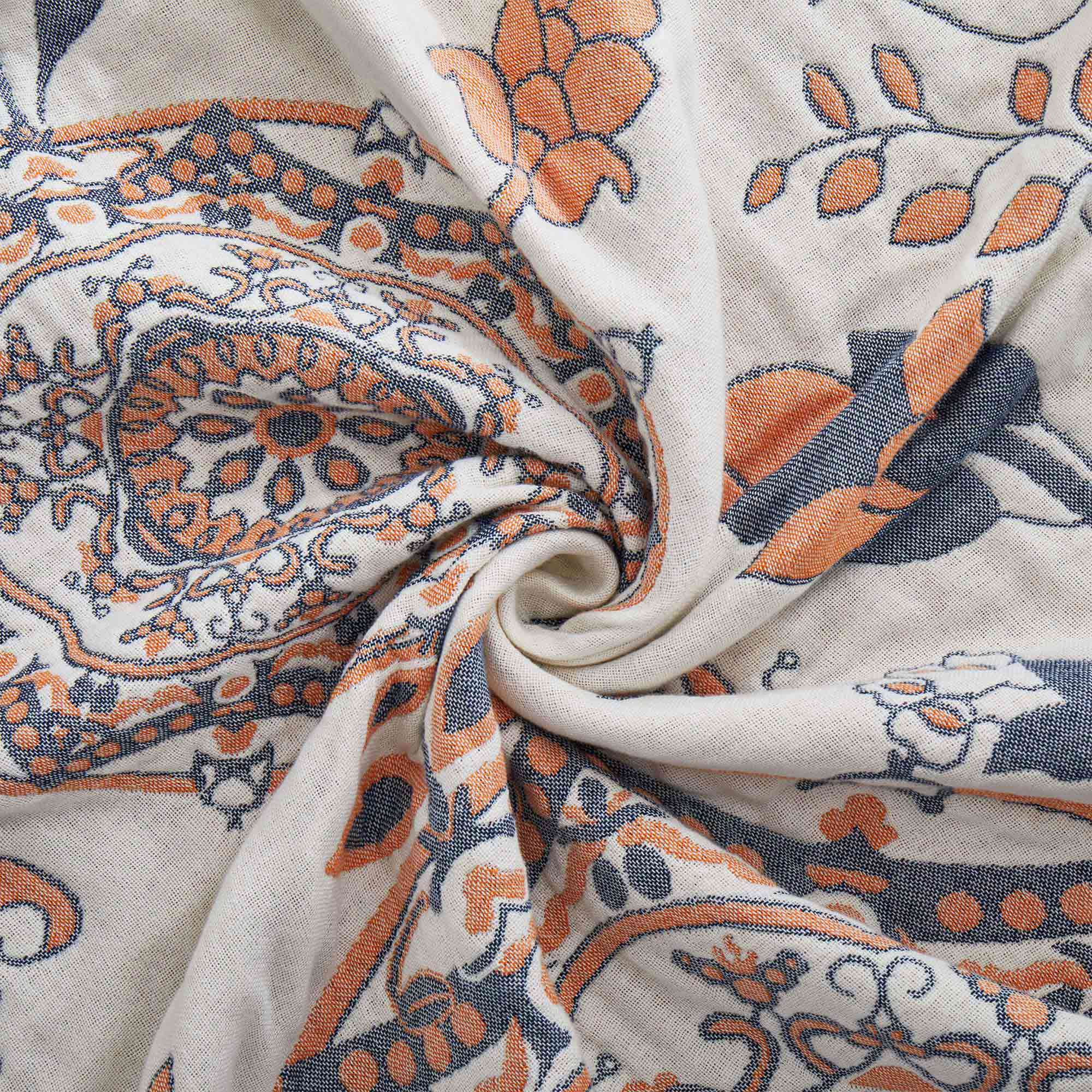 Cream-colored velvet throw blanket with intricate orange and navy medallion and vine patterns, finished with a navy blue border.