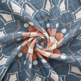 Cream-colored velvet throw blanket with intricate orange and navy medallion and vine patterns, finished with a navy blue border.