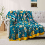 Teal floral velvet throw blanket with yellow and white flower patterns and a golden yellow border.