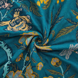 Teal floral velvet throw blanket with yellow and white flower patterns and a golden yellow border.