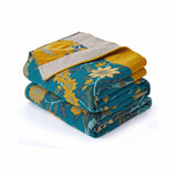 Teal floral velvet throw blanket with yellow and white flower patterns and a golden yellow border.
