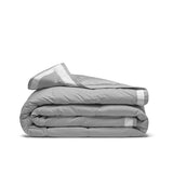 The summer cooling blanket is covered in the somber hues of gray with a complementing white trim. Bring refreshing sophistication to your personal space with this down duvet insert in gray.