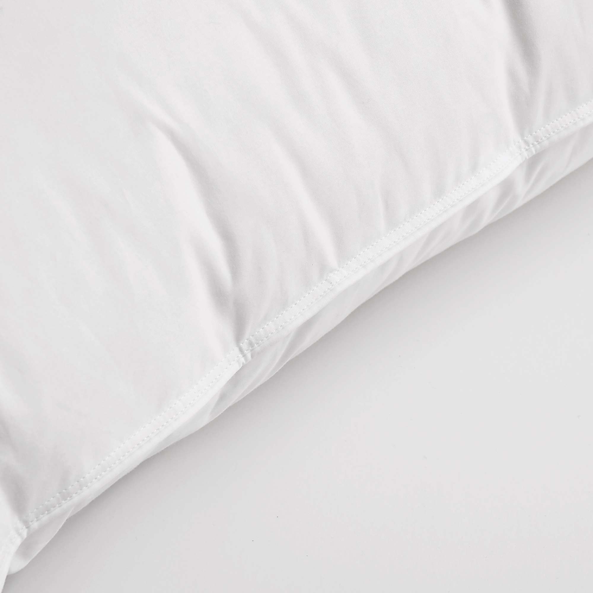 Made with down in pillows with feathers, this german down feather pillow is covered in crisp white hues. Add a touch of classic intrigue to your bedspace with this down feather pillow in white.