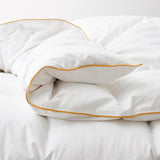 The all season down comforter is covered in the solid color of white. Add brightness and light to your room with this goose-down comforter.