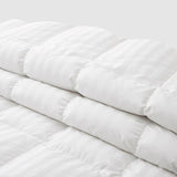 The all season down comforter is covered in the solid color of white. Add brightness and light to your room with this goose-down comforter.