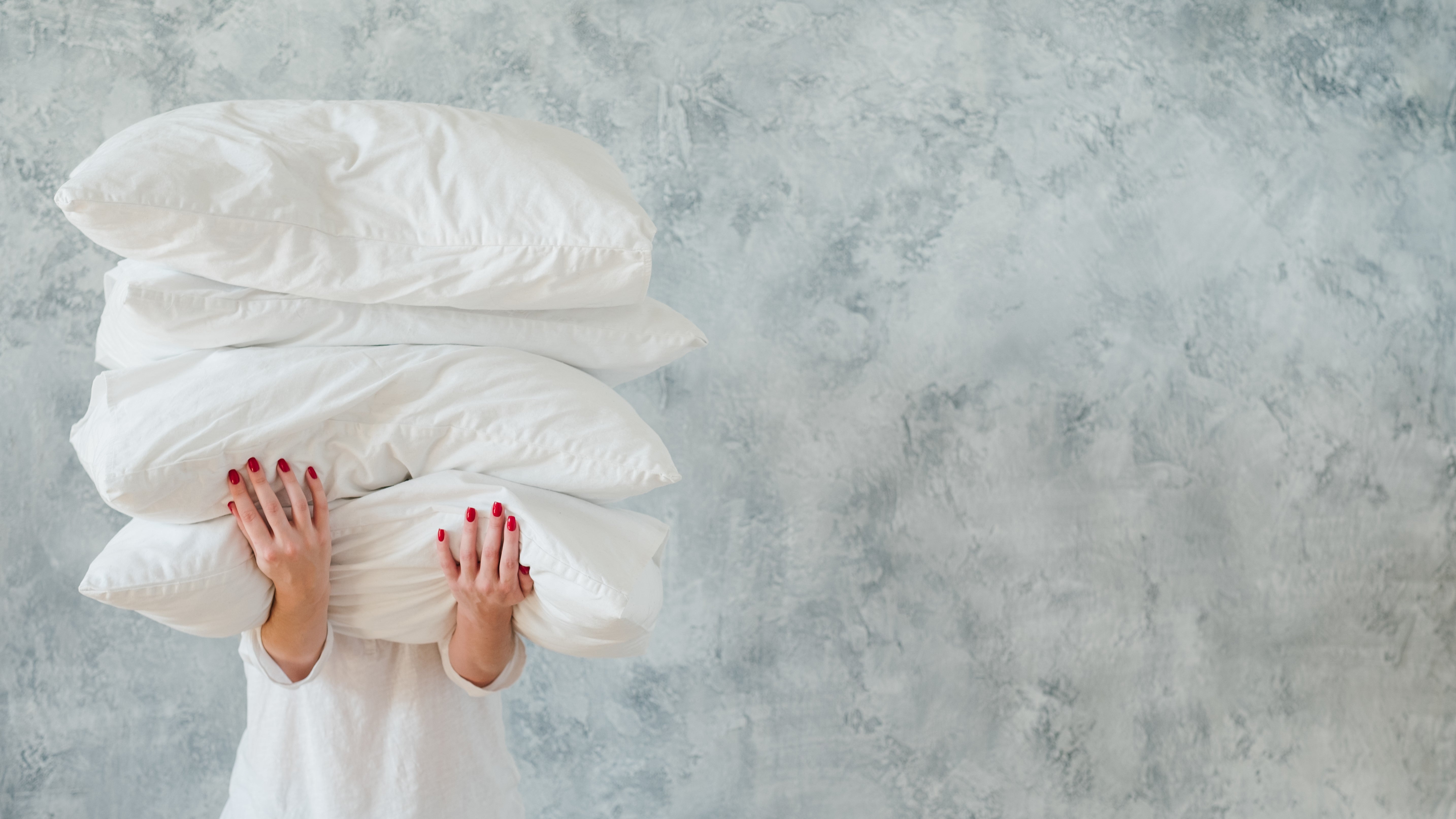 Person holding pillows