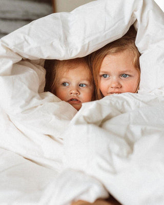 two children under a blanket