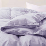 Elevate your sleep sanctuary with the calming elegance of our Lavender Organic Cotton Down Comforter. This soft lavender shade adds a touch of serenity and gentle color to your bedroom, making it a perfect choice for creating a peaceful, spa-like atmosphere. Crafted from 100% GOTS-certified organic cotton and generously filled with down and feather fiber, this comforter is breathable, lightweight, and ideal for all seasons. Whether you're a hot sleeper or need cozy layering in cooler months, its natural ins