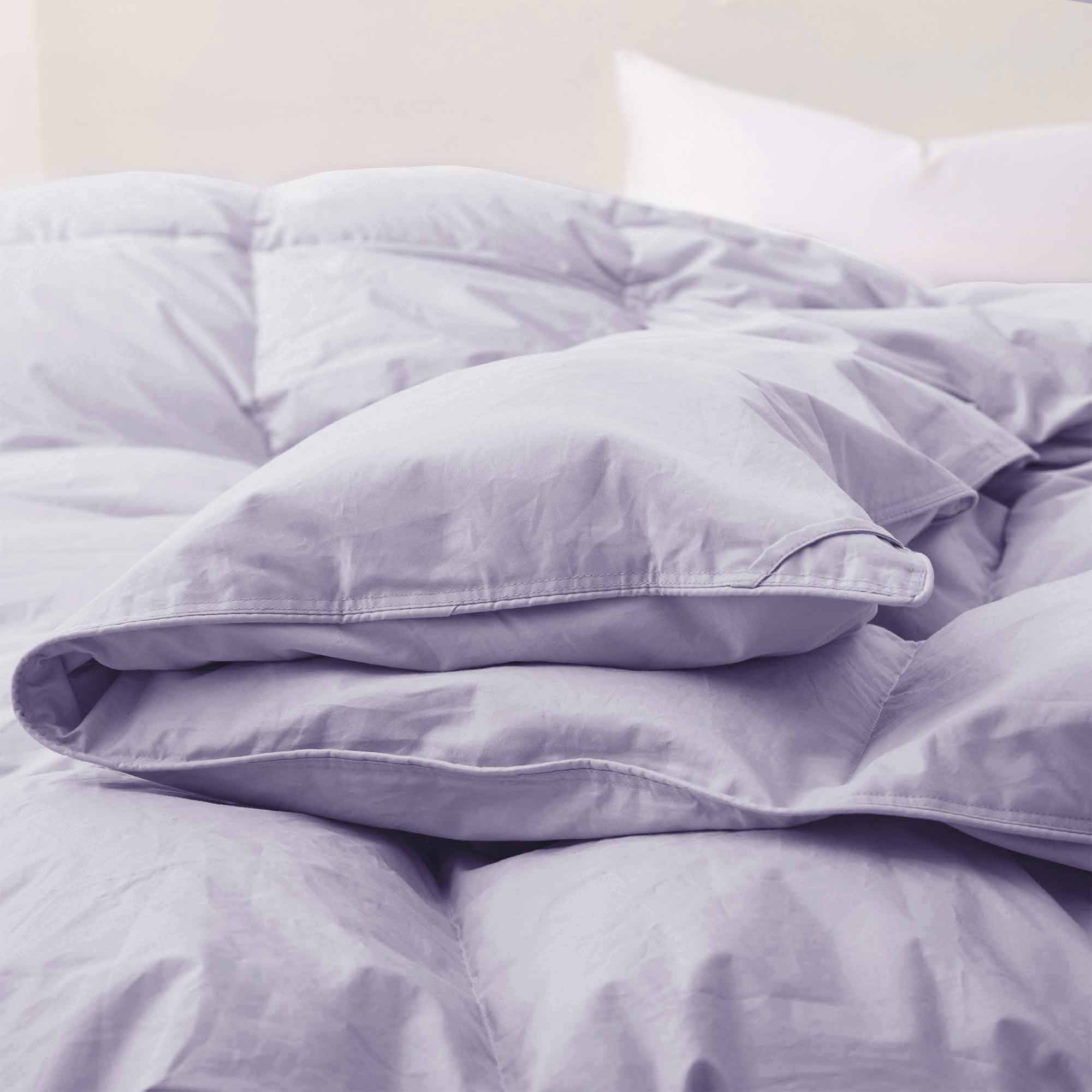 Elevate your sleep sanctuary with the calming elegance of our Lavender Organic Cotton Down Comforter. This soft lavender shade adds a touch of serenity and gentle color to your bedroom, making it a perfect choice for creating a peaceful, spa-like atmosphere. Crafted from 100% GOTS-certified organic cotton and generously filled with down and feather fiber, this comforter is breathable, lightweight, and ideal for all seasons. Whether you're a hot sleeper or need cozy layering in cooler months, its natural ins