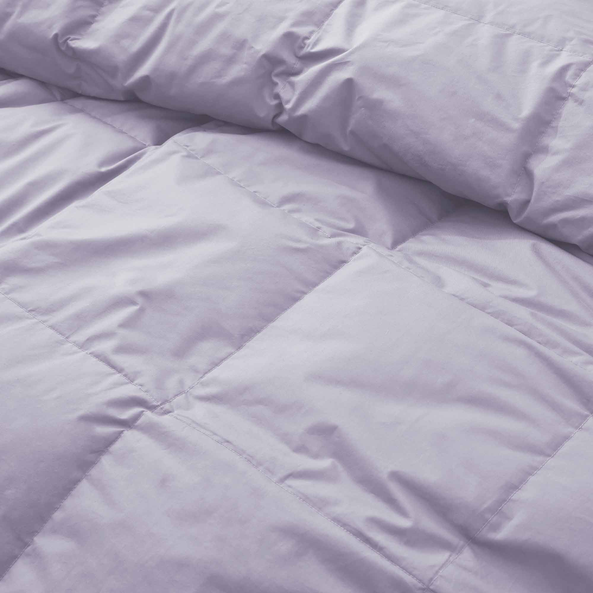 Elevate your sleep sanctuary with the calming elegance of our Lavender Organic Cotton Down Comforter. This soft lavender shade adds a touch of serenity and gentle color to your bedroom, making it a perfect choice for creating a peaceful, spa-like atmosphere. Crafted from 100% GOTS-certified organic cotton and generously filled with down and feather fiber, this comforter is breathable, lightweight, and ideal for all seasons. Whether you're a hot sleeper or need cozy layering in cooler months, its natural ins