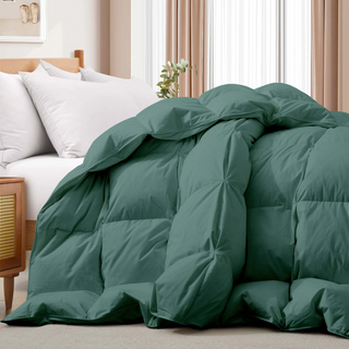 The down feather comforter is brushed in medium tones of forest green. Add a natural element to your bedroom style with this green color medium weight comforter.