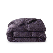 The luxury down bedding is covered in deep purple tones with soft flower and leaf patterns, evoking natural vibes.