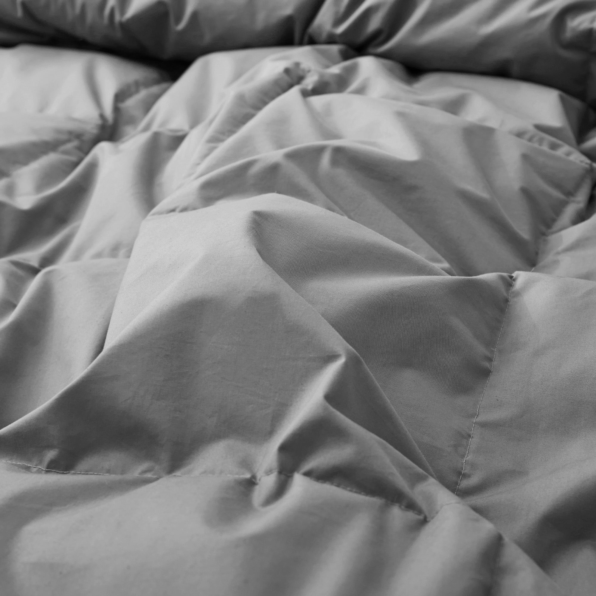Indulge in the luxurious softness and durability of our organic comforter option in a versatile and chic gray shade, offering a cozy and sustainable way to enrich your sleep experience and enhance your bed in luxury style.