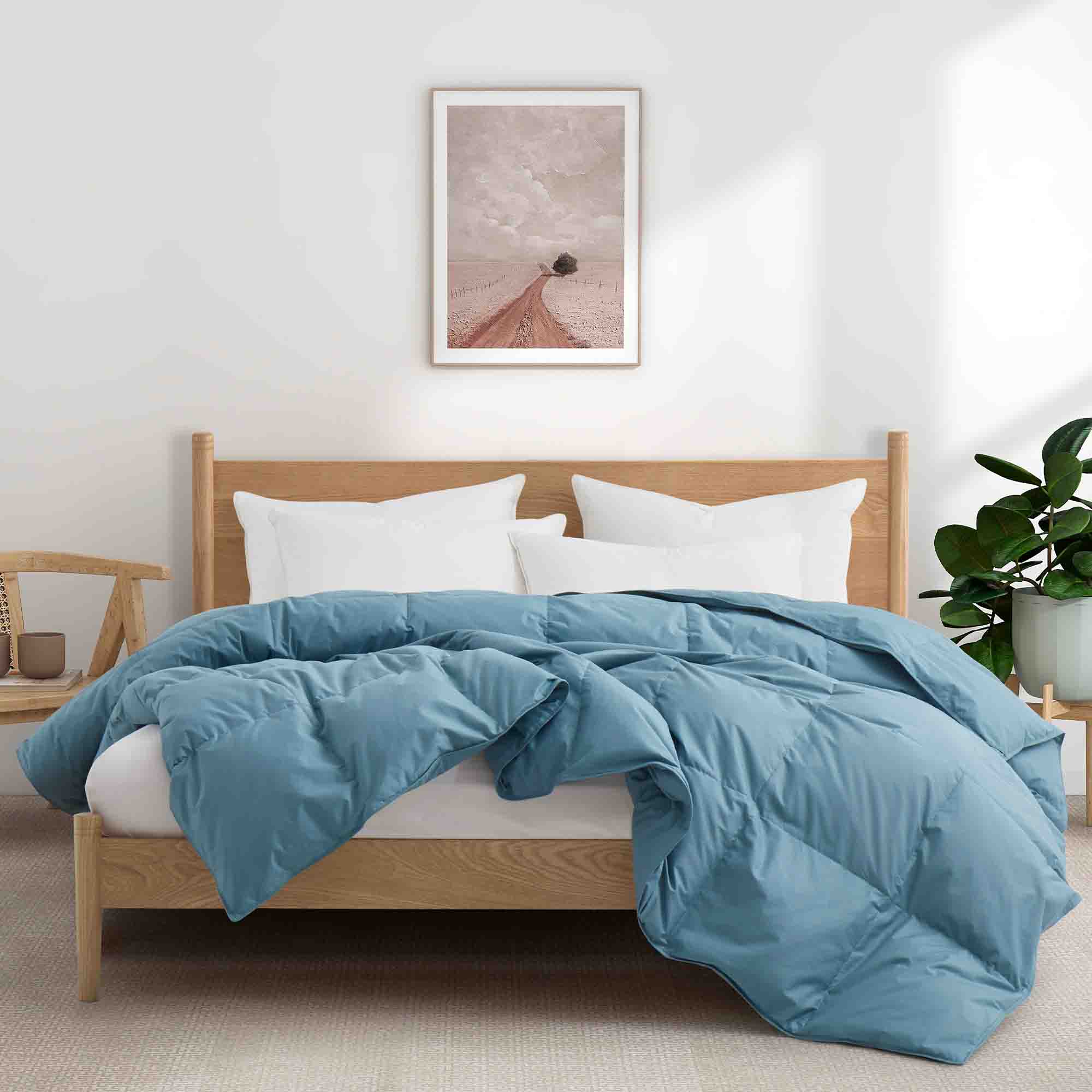 All-season castle blue organic cotton comforter filled with down feather fiber, featuring breathable fabric and box-stitch construction for even fill distribution.