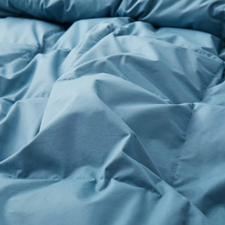 Add a touch of understated elegance to your bedding collection with our all-season comforter weight duvet in sophisticated steel blue hues, offering maximum loft to elevate your sleep experience.