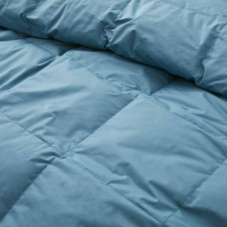 Add a touch of understated elegance to your bedding collection with our all-season comforter weight duvet in sophisticated steel blue hues, offering maximum loft to elevate your sleep experience.