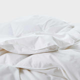 Experience timeless comfort with our White Organic Cotton Down Comforter — a must-have for those who value clean, classic bedding. Crafted from GOTS-certified organic cotton and filled with 100% down and feather fiber, this breathable and lightweight comforter is perfect for all-season use. The crisp white color creates a fresh, hotel-quality look while offering unmatched softness and natural temperature regulation. Whether styled alone or layered with other bedding, this white comforter elevates any bedroo