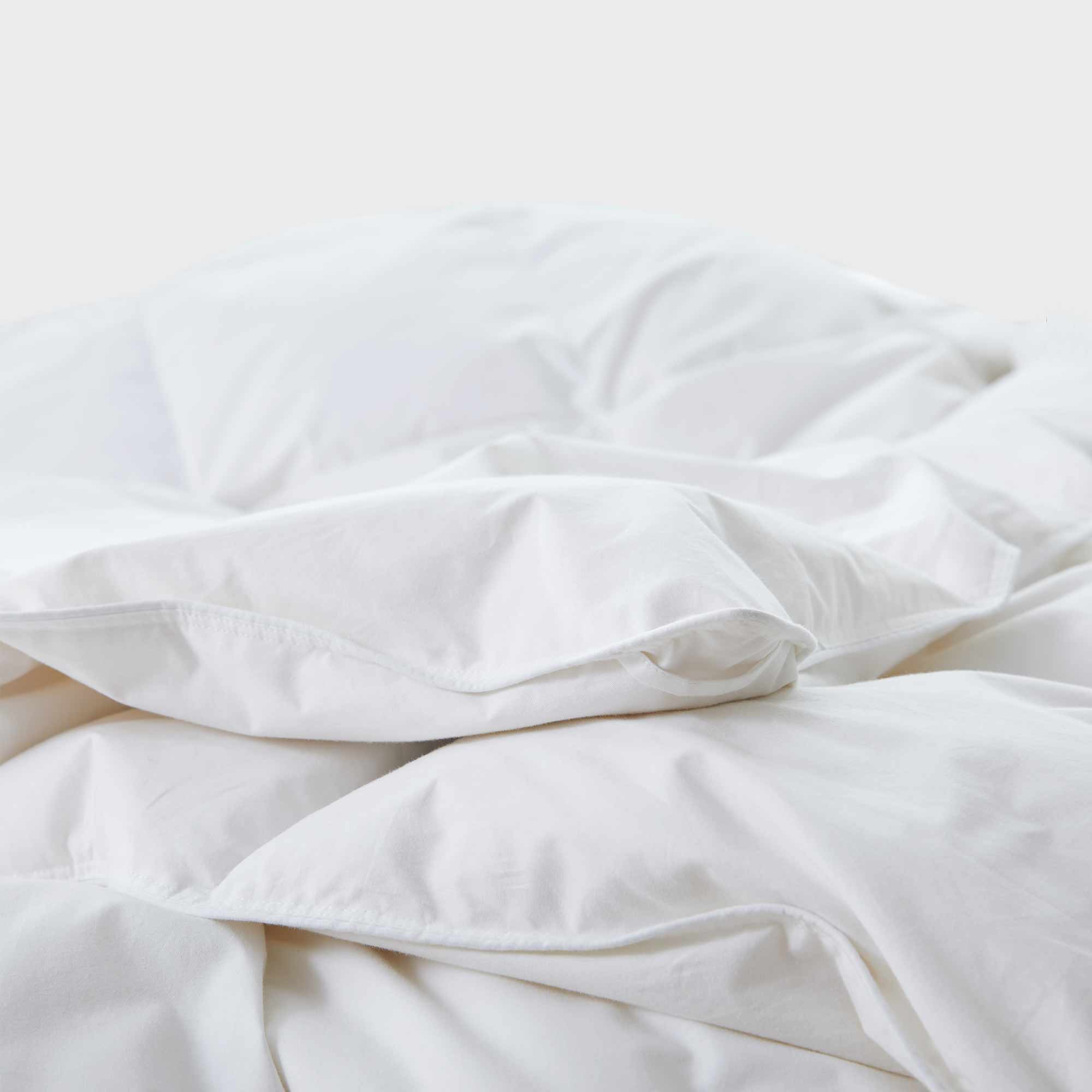 Experience timeless comfort with our White Organic Cotton Down Comforter — a must-have for those who value clean, classic bedding. Crafted from GOTS-certified organic cotton and filled with 100% down and feather fiber, this breathable and lightweight comforter is perfect for all-season use. The crisp white color creates a fresh, hotel-quality look while offering unmatched softness and natural temperature regulation. Whether styled alone or layered with other bedding, this white comforter elevates any bedroo