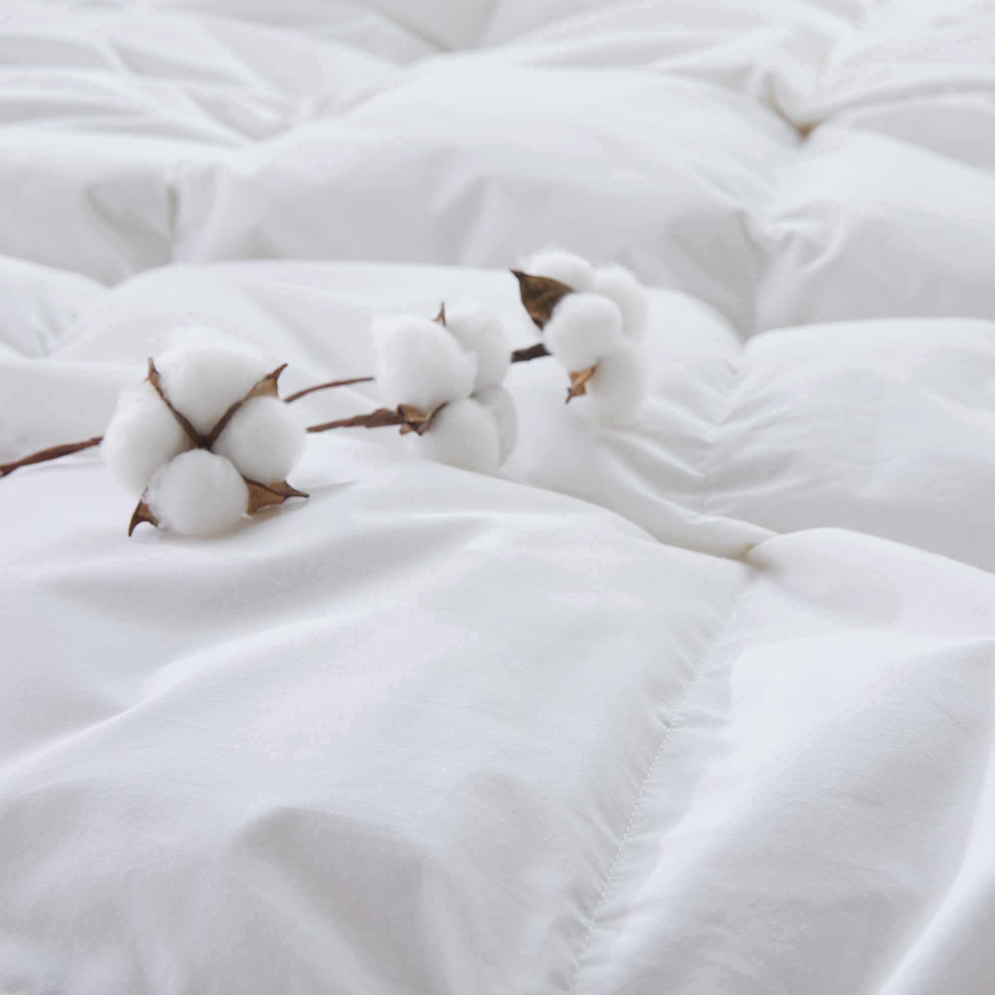 Experience timeless comfort with our White Organic Cotton Down Comforter — a must-have for those who value clean, classic bedding. Crafted from GOTS-certified organic cotton and filled with 100% down and feather fiber, this breathable and lightweight comforter is perfect for all-season use. The crisp white color creates a fresh, hotel-quality look while offering unmatched softness and natural temperature regulation. Whether styled alone or layered with other bedding, this white comforter elevates any bedroo