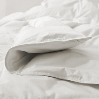 The lightest organic cotton comforter with feathers is covered in crisp tones of white. Add a touch of contemporary finesse to your bedroom or bedding option with this white cover feather down comforter.