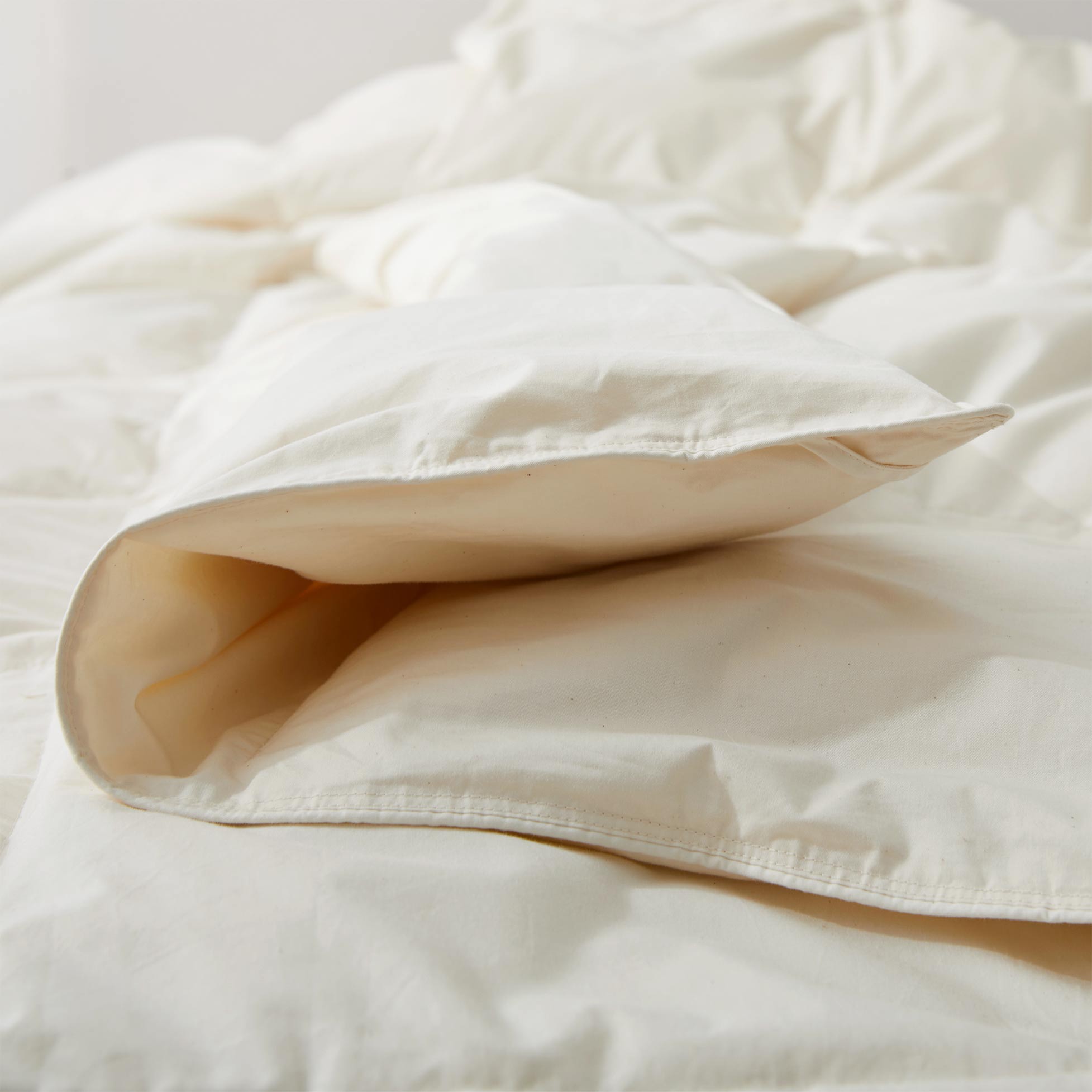 The lightest weight down comforter with feathers is covered in crisp tones of off white. Add a touch of contemporary finesse to your bedroom or bedding option with this off-white cover feather down comforter.