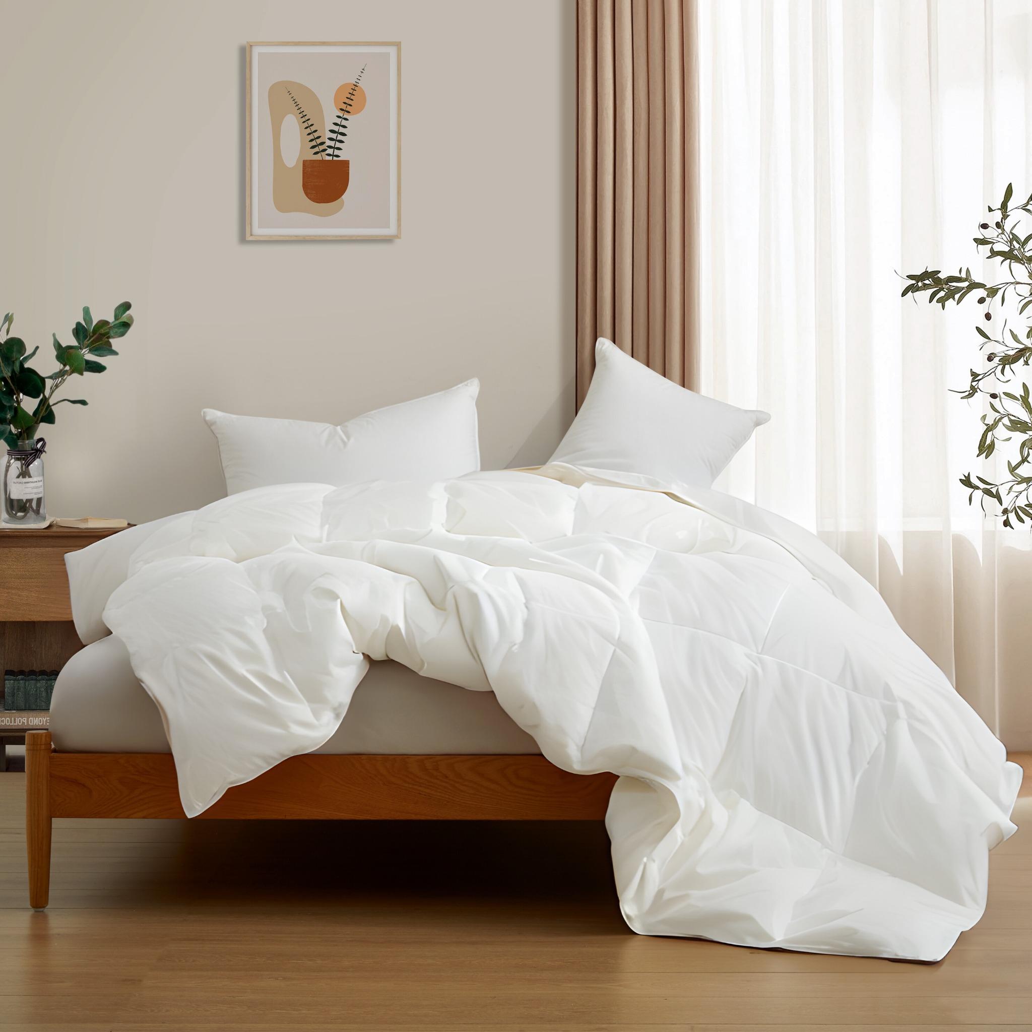 The lightest organic cotton comforter with feathers is covered in crisp tones of white. Add a touch of contemporary finesse to your bedroom or bedding option with this white cover feather down comforter.