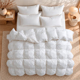 Top-down view of a Puredown Luxury White Goose Down Comforter on a bed with four white pillows.