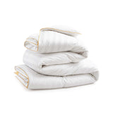 The all season down comforter is colored in fresh tones of white. Add brightness and light to your room with this goose-down comforter.