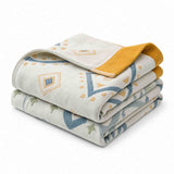 The Boho Cotton Throw Blanket features folded, patterned cotton jacquard with yellow, blue, and green geometric designs and a mustard yellow edge. This stylish multi-color blanket adds a vibrant accent to your space.