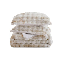 Brown faux rabbit fur comforter set styled with sherpa reverse and coordinating zip-closure pillow shams, offering a warm and elegant bedroom look.