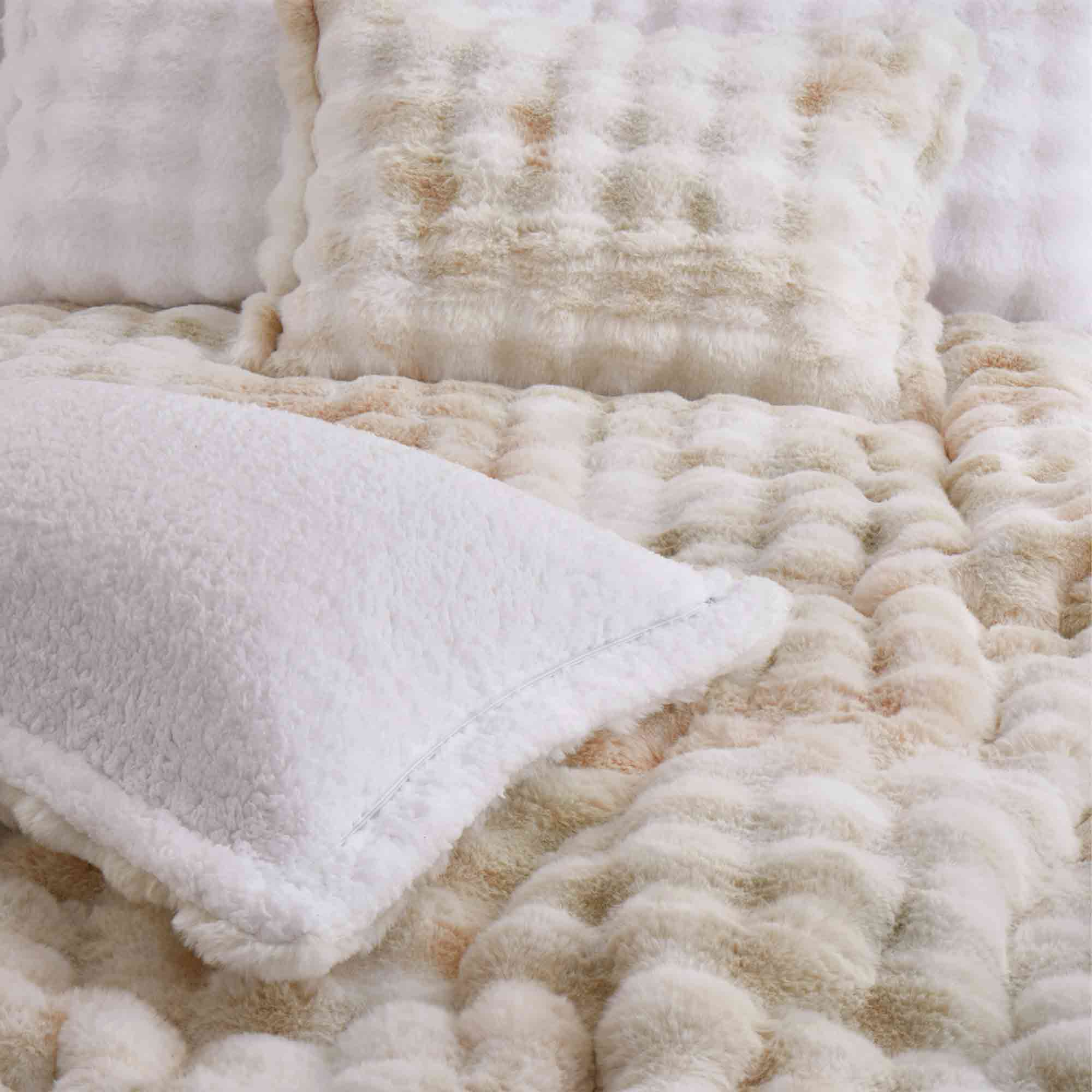Brown faux rabbit fur comforter set styled with sherpa reverse and coordinating zip-closure pillow shams, offering a warm and elegant bedroom look.