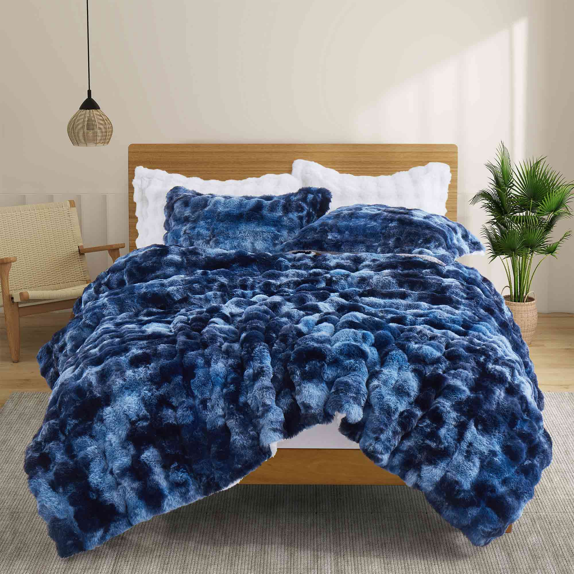 Navy faux rabbit fur comforter set featuring a reversible sherpa lining and pillow shams, adding a bold yet inviting touch to the bedroom.
