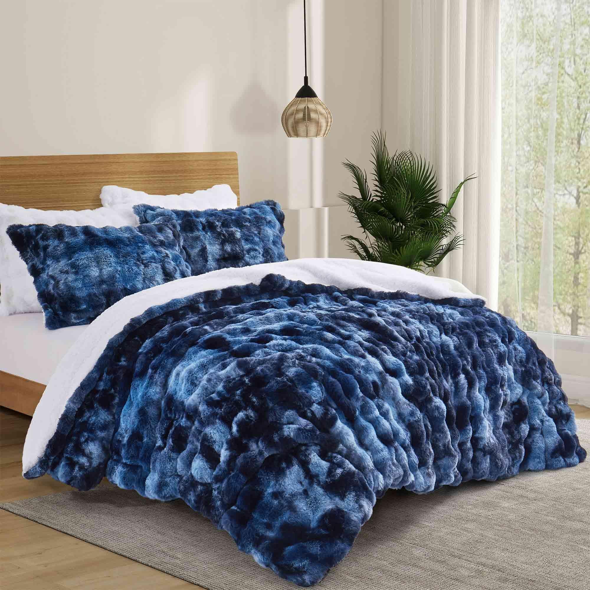 Navy faux rabbit fur comforter set featuring a reversible sherpa lining and pillow shams, adding a bold yet inviting touch to the bedroom.