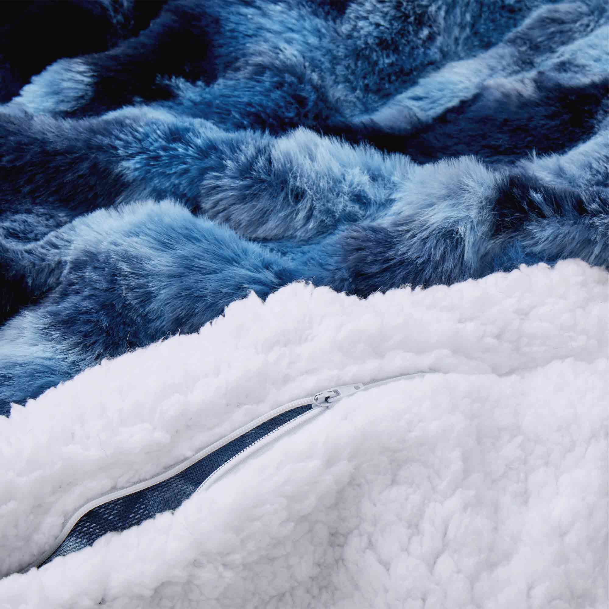 Navy faux rabbit fur comforter set featuring a reversible sherpa lining and pillow shams, adding a bold yet inviting touch to the bedroom.