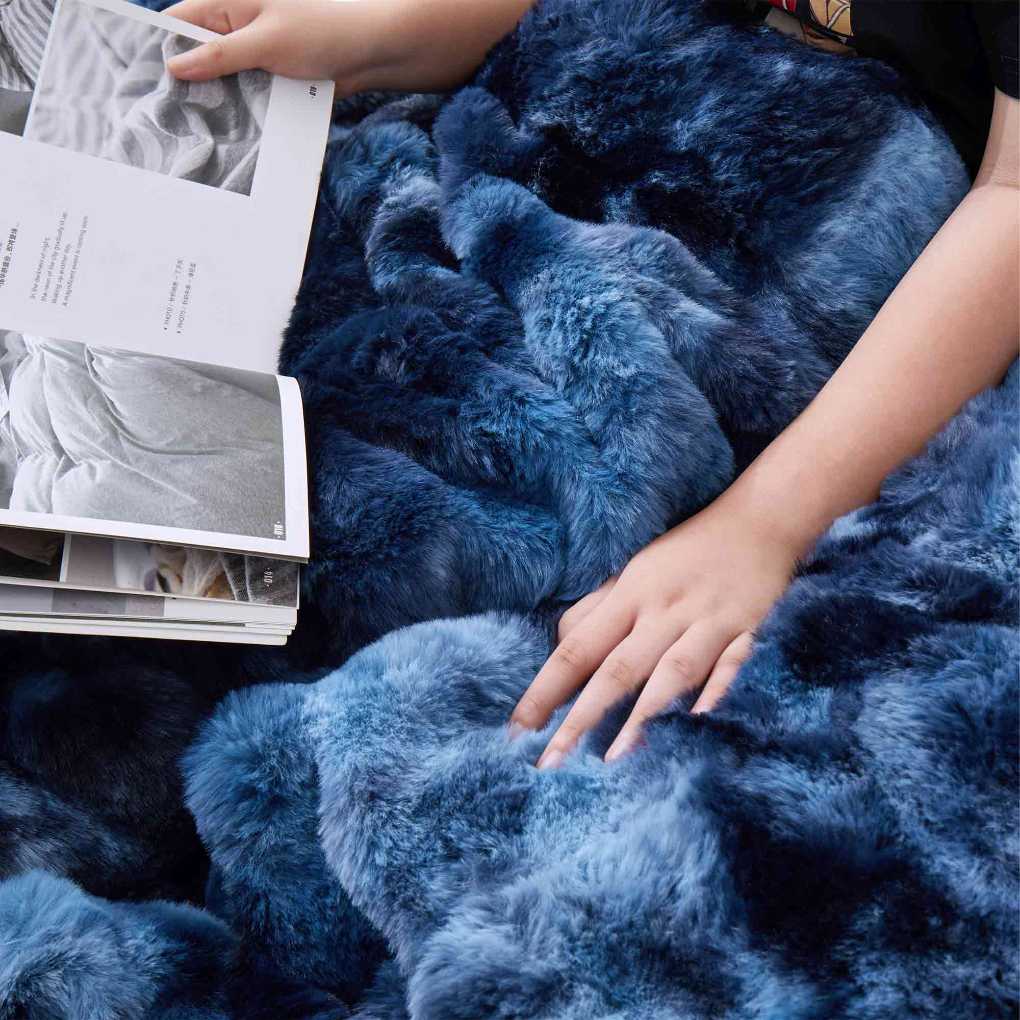 Navy faux rabbit fur comforter set featuring a reversible sherpa lining and pillow shams, adding a bold yet inviting touch to the bedroom.