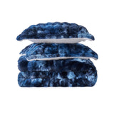 Navy faux rabbit fur comforter set featuring a reversible sherpa lining and pillow shams, adding a bold yet inviting touch to the bedroom.