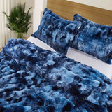 Navy faux rabbit fur comforter set featuring a reversible sherpa lining and pillow shams, adding a bold yet inviting touch to the bedroom.